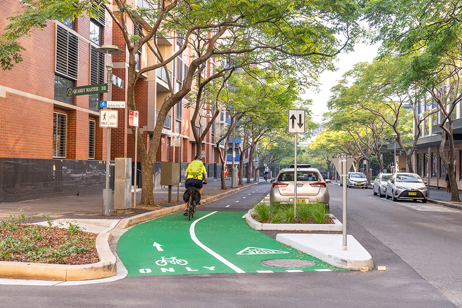 A cyclist follows the dual-way cycleway on Saunders Street towards Sydney CBD.