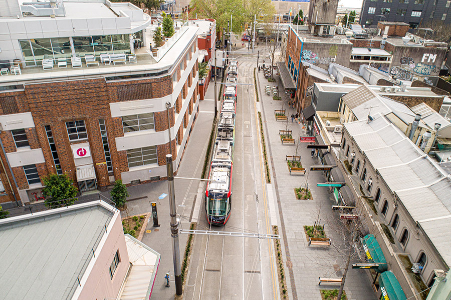 An overhead view of a tram travelling down George Street in Sydney CBD with the new footpath and seating areas visible.
