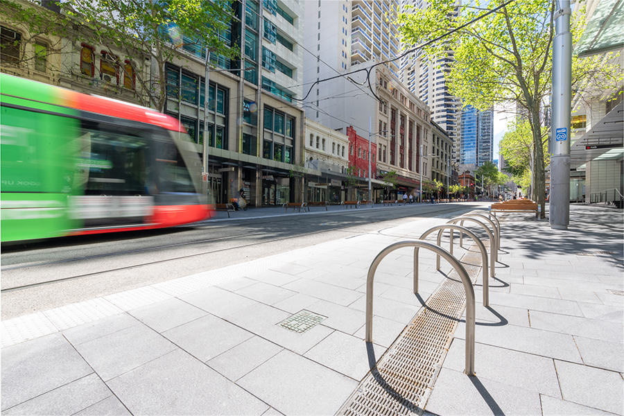 A tram travels up the newly revamped streetscape of George Street in Sydney CBD.
