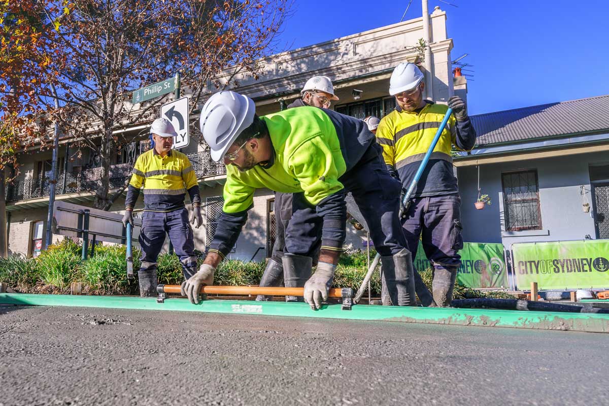 Workers in high vis, levelling concrete on Phillip Street in Sydney