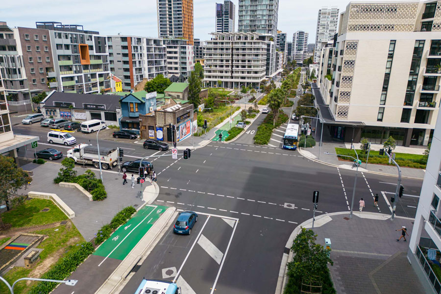 An overhead view of the Gadigal Ave and Lachland St intersection with cycleway and landscaping down the middle.