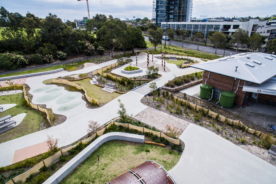 An overhead view of the bike track at Sydney Park, Alexandria, focusing on the paths and obstacles with a building.