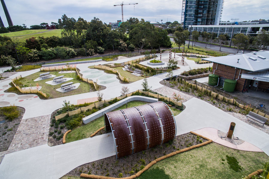 An overhead view of the bike track at Sydney Park in Alexandria with a tunnel, picnic tables and shelter building.