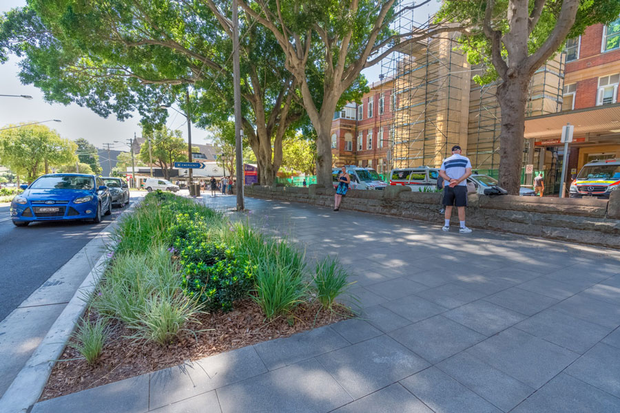 Pedestrians enjoy the shade of the new landscaping and footway in the Missendon Road streetscape.