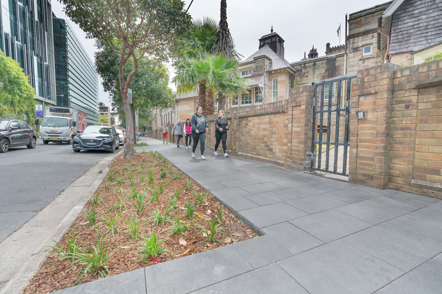 Pedestrians enjoying the new footpath and landscaping along Missendon Road in Camperdown.